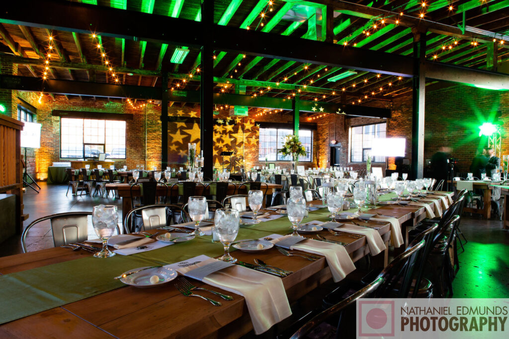 Wooden tables set up for a holiday party reception at INDUSTRY in Indianapolis, Indiana