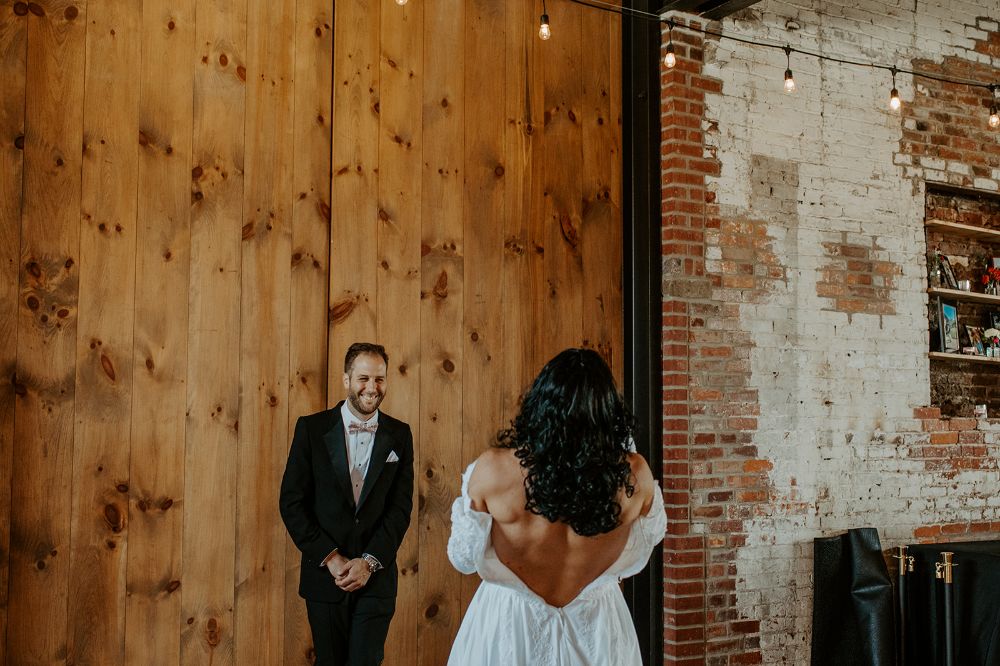 A series of photos of a first look of a bride and groom at INDUSTRY in Indianapolis
