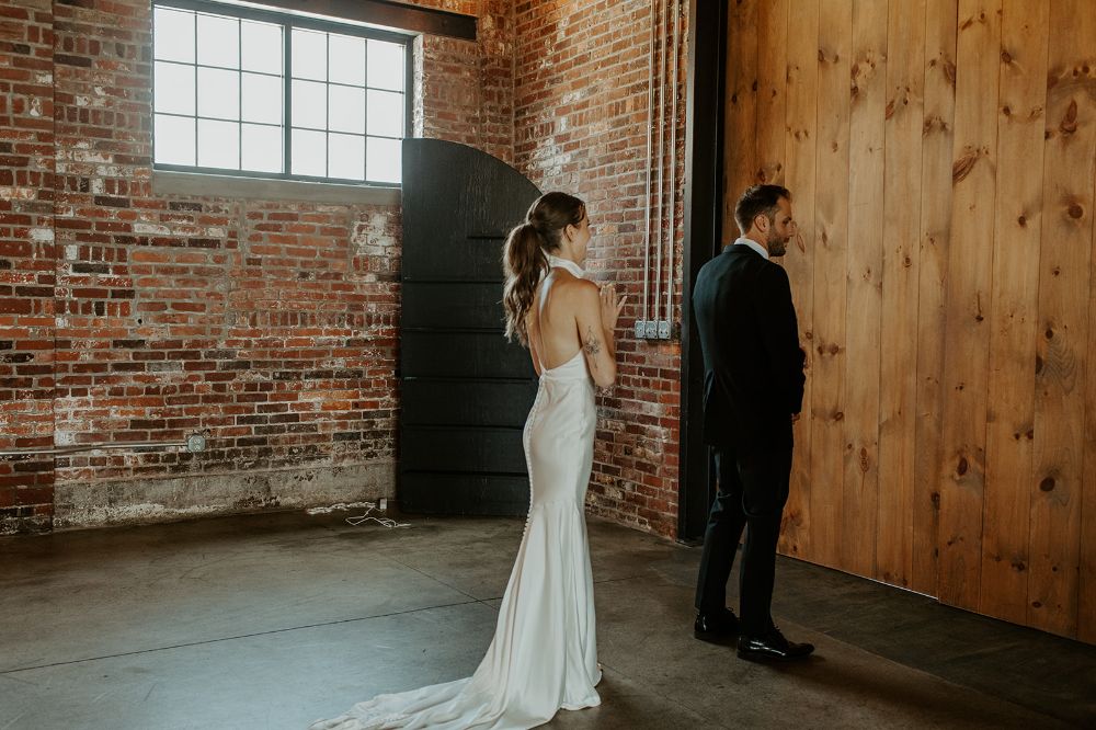 A series of photos of a first look of a bride and groom at INDUSTRY in Indianapolis