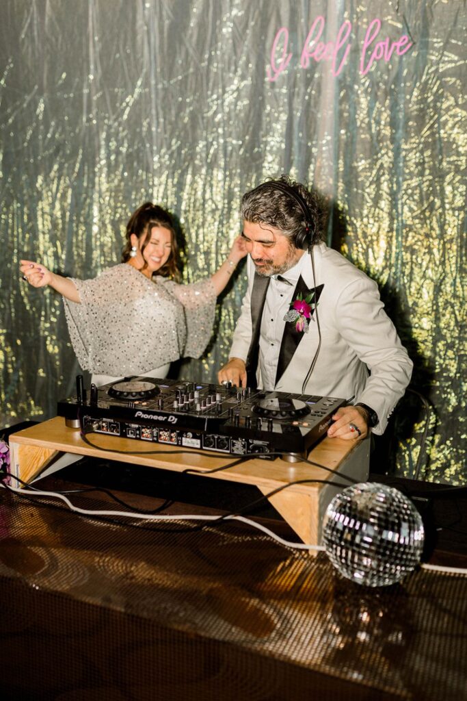 Bride and groom playing DJ