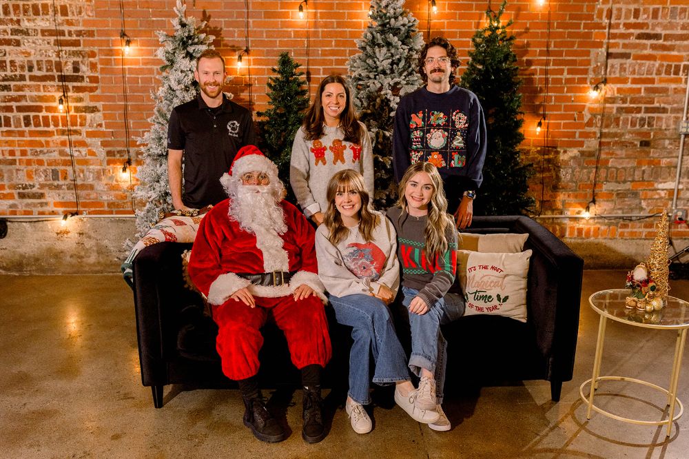 INDUSTRY team in front of a holiday backdrop