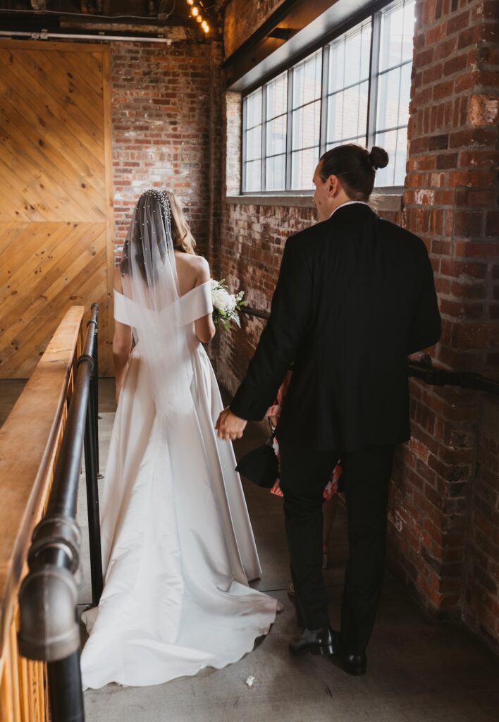 Bride and groom walking down a ramp at INDUSTRY