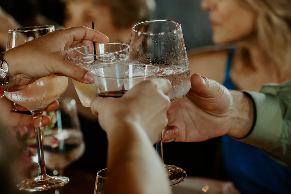 Guests cheers-ing at a wedding