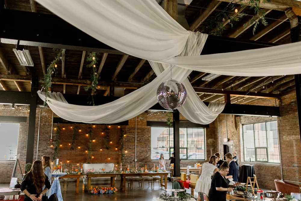 Draping hanging from the ceiling with a disco ball in the middle at INDUSTRY in Indianapolis, IN