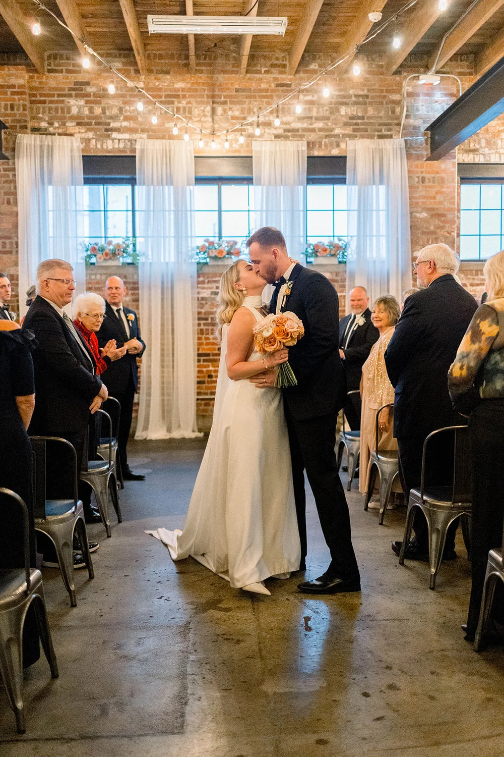 Bride and groom kissing after their wedding ceremony