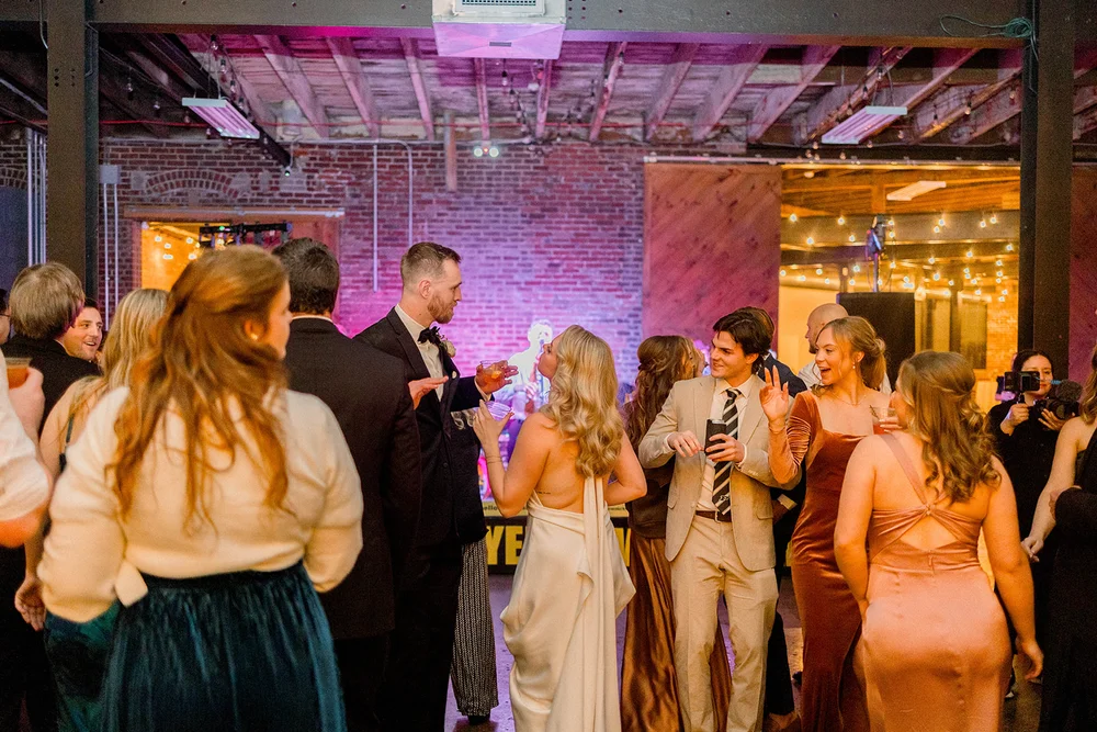 Guests dancing to live music at a wedding at INDUSTRY in Indianapolis, IN