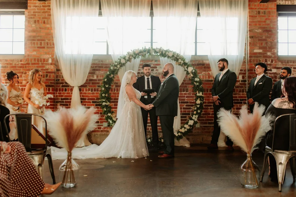 Bride and groom exchanging vows at INDUSTRY, Indianapolis wedding venue