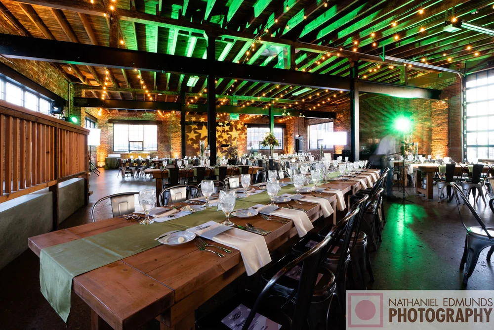 Nonprofit gala at INDUSTRY in downtown Indianapolis with bright green mood lighting and professional AV setup
